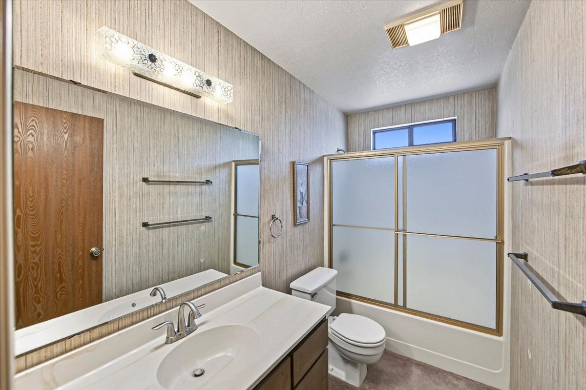 Hall bathroom with a vanity and tub-shower at 4184 N Kearny Dr