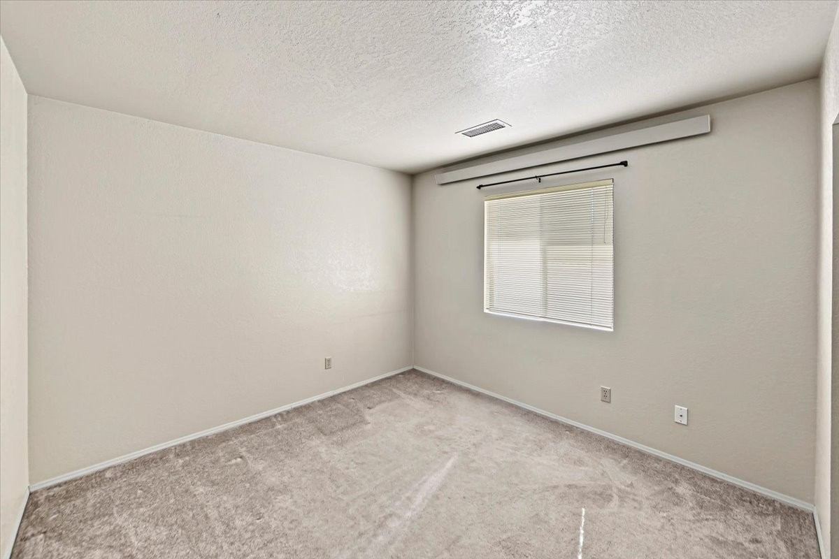 Second bedroom with a window and ceiling vent at 4184 N Kearny Dr