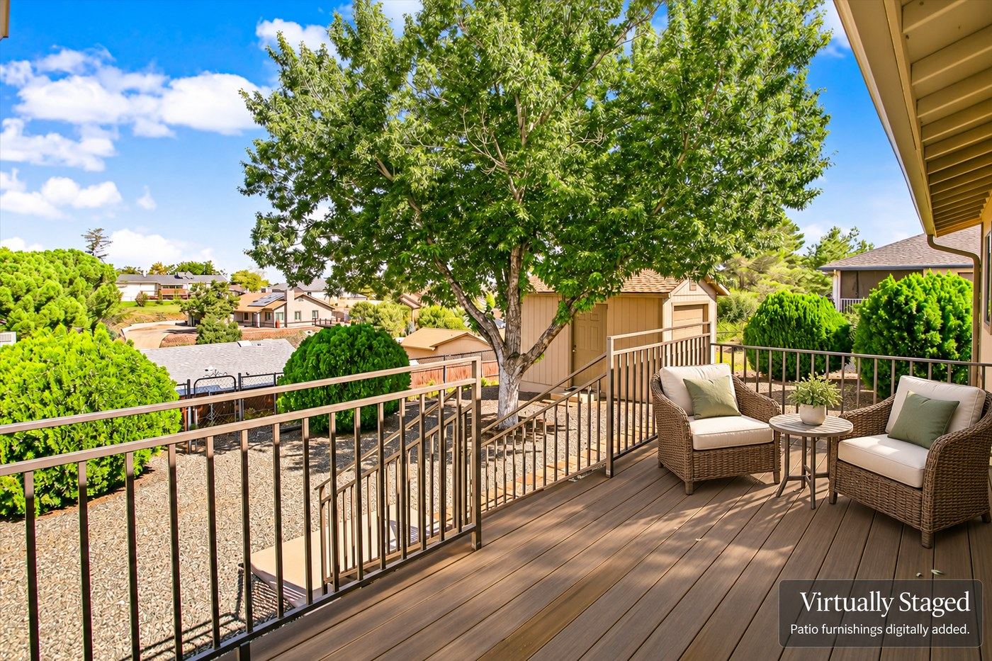 Virtually staged version of the rear deck at 4184 N Kearny Dr with patio furniture digitally added