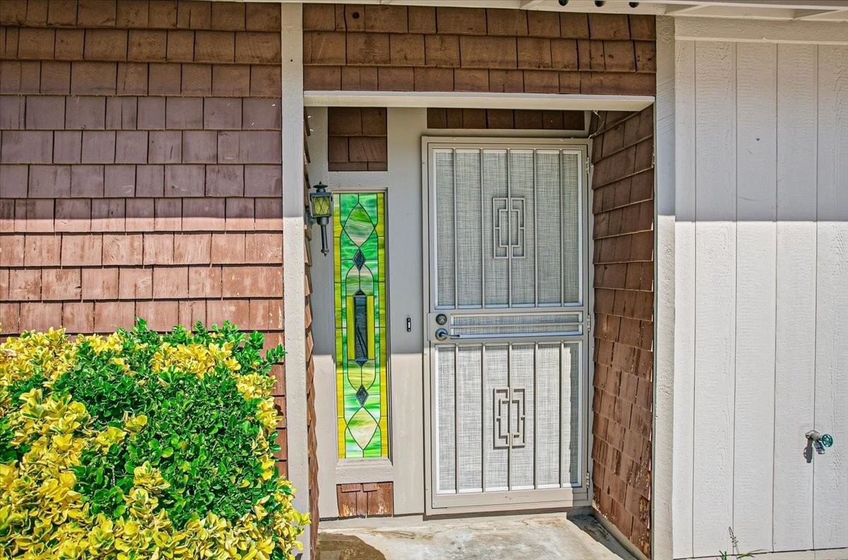Front entry with a security door and stained glass accent at 4184 N Kearny Dr
