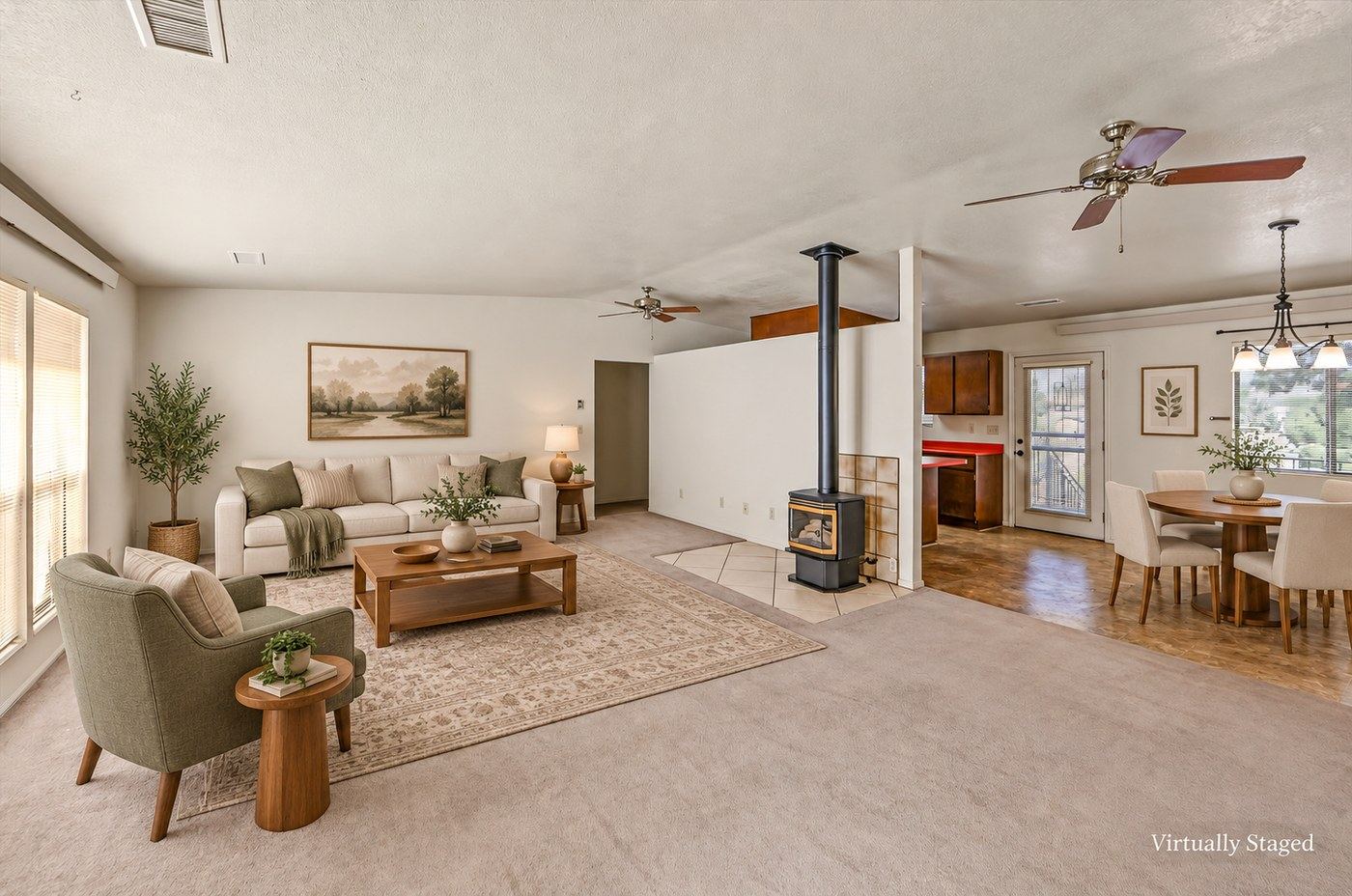 Virtually staged version of the living and dining area at 4184 N Kearny Dr with furniture and decor digitally added