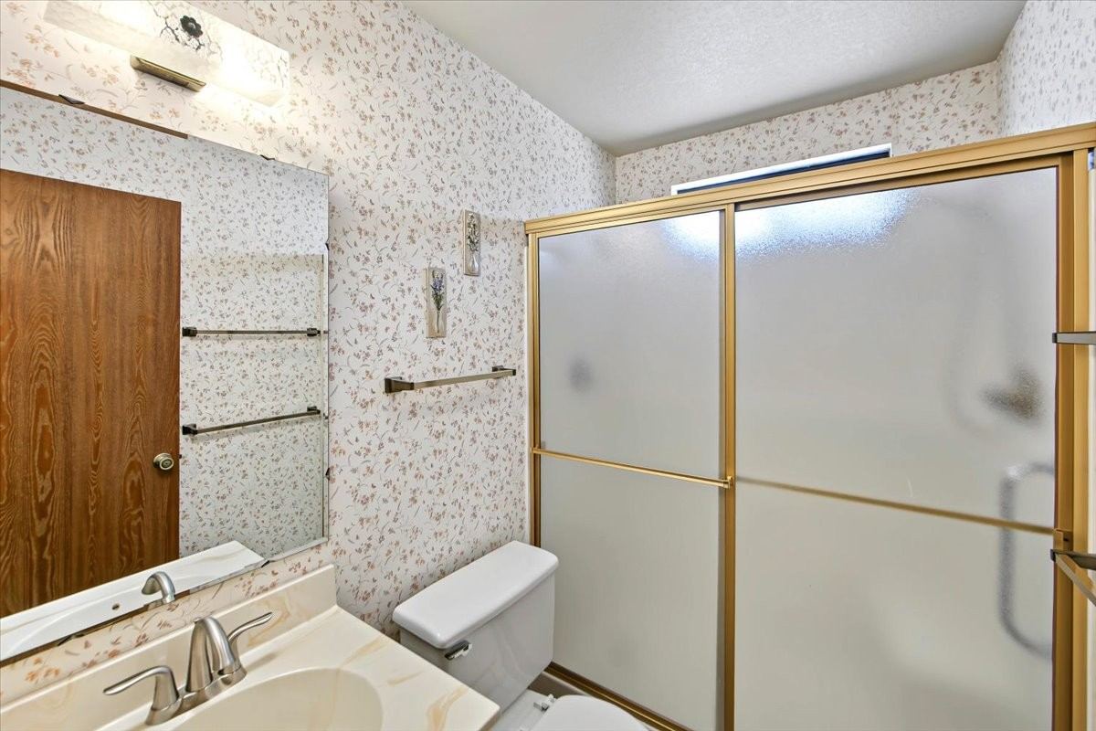 Primary bathroom with a gold-framed shower door at 4184 N Kearny Dr
